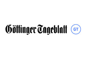 Logo der Zeitung Göttinger Tageblatt mit ihrem Namen in schwarzer Frakturschrift, rechts ein blauer Kreis mit den Initialen „GT“, erinnert an Eleganz und Bewegung wie ein Meisterwerk von Laufen.